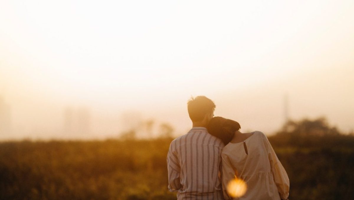 man-and-woman-near-grass-field-golden-hour